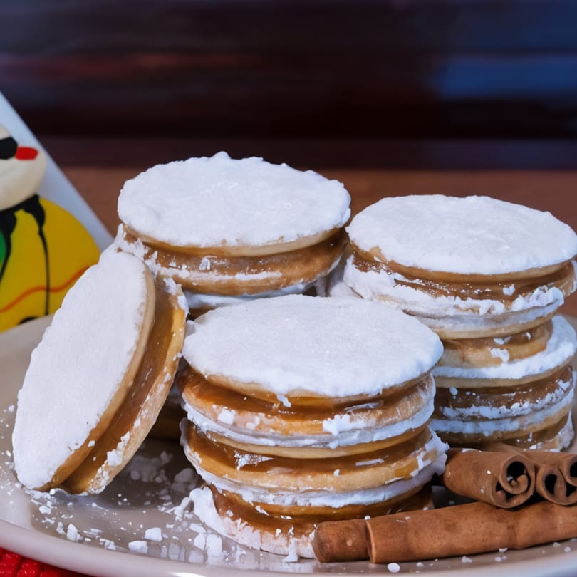 Don Pollo's Peruvian alfajores, dulce de leche cookies dusted with powdered sugar, and cinnamon sticks.